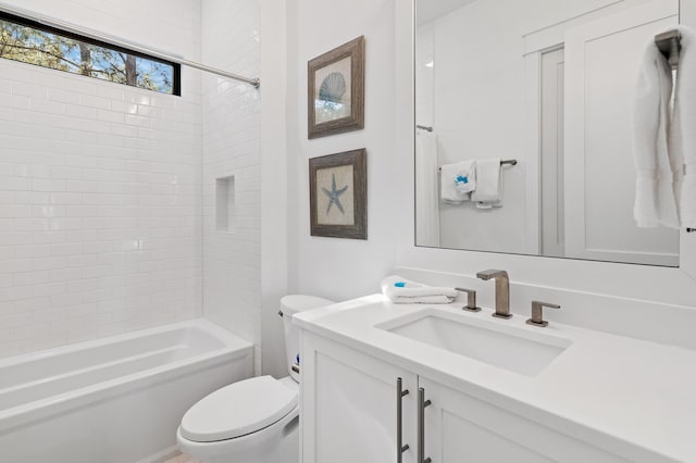 full bathroom with vanity, toilet, and tiled shower / bath combo