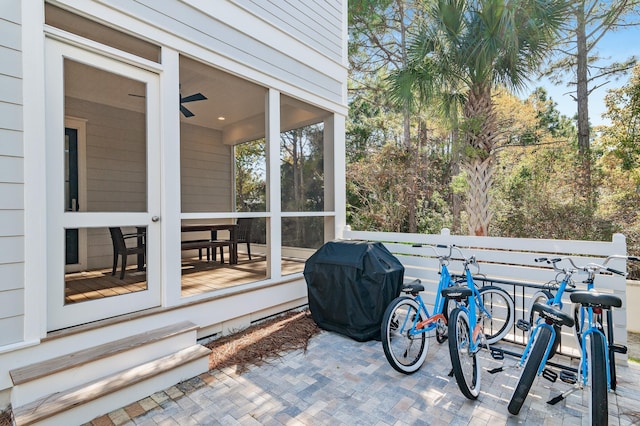 view of patio / terrace featuring grilling area and a sunroom