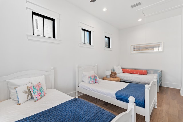 bedroom with dark hardwood / wood-style floors