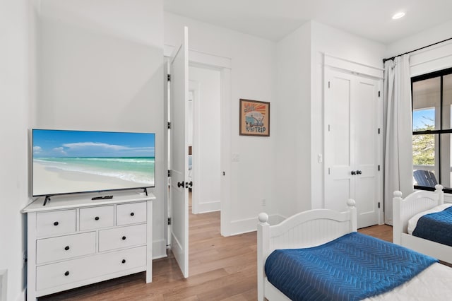 bedroom with wood-type flooring and a closet