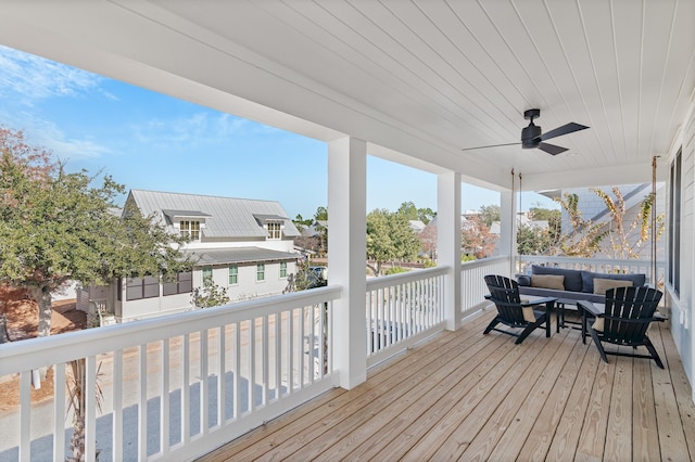 deck featuring ceiling fan and an outdoor living space