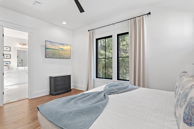 bedroom featuring ensuite bath, ceiling fan, and light hardwood / wood-style floors