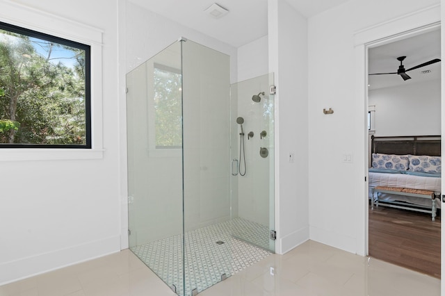 bathroom featuring tile patterned floors, ceiling fan, and an enclosed shower