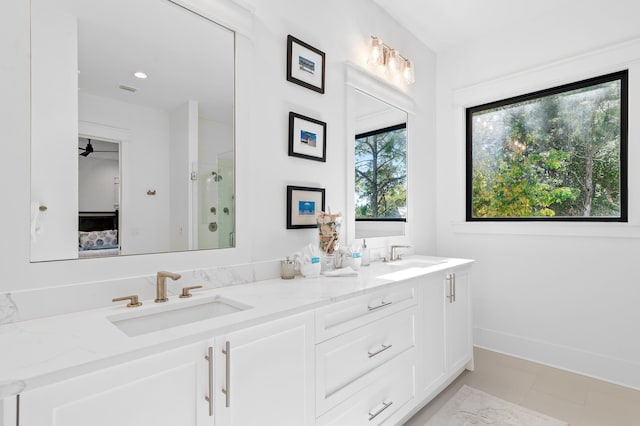 bathroom with vanity, a shower with door, tile patterned floors, and plenty of natural light