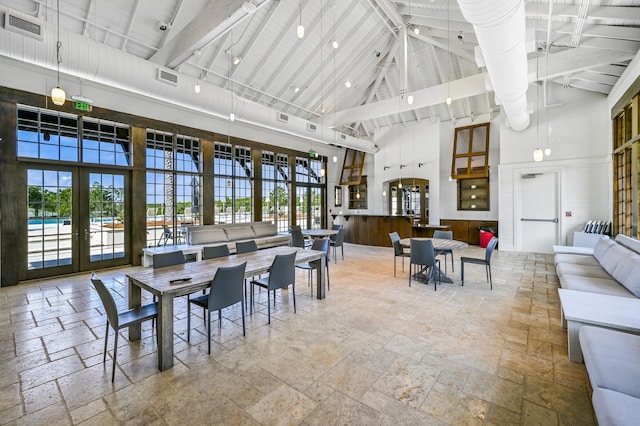 dining area with french doors, high vaulted ceiling, and beam ceiling