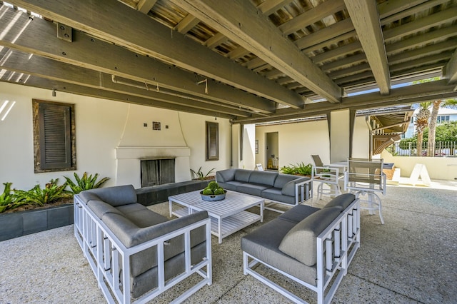 view of patio / terrace with an outdoor living space with a fireplace