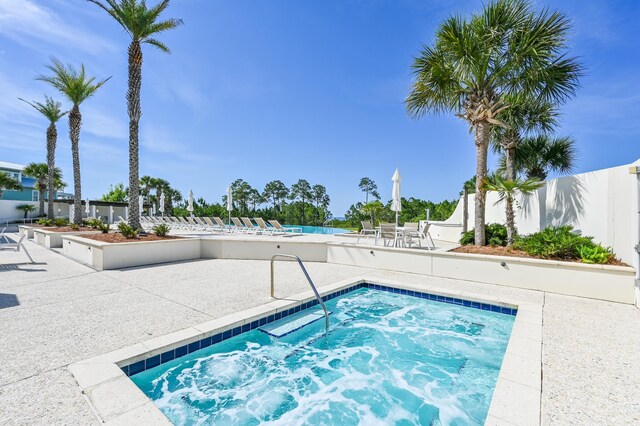 view of pool with a community hot tub and a patio