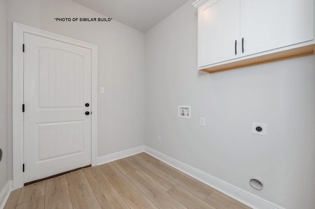 washroom with hookup for an electric dryer, washer hookup, baseboards, cabinet space, and light wood finished floors