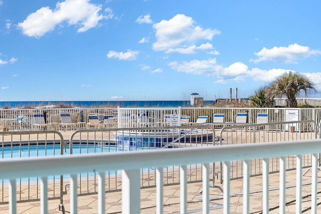 view of pool with a water view