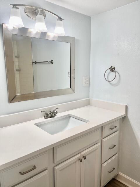 bathroom featuring vanity and hardwood / wood-style flooring