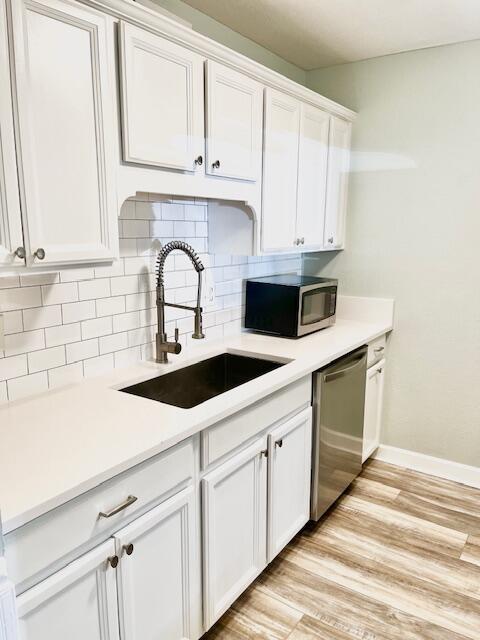 kitchen featuring sink, white cabinetry, and stainless steel appliances