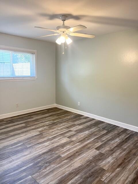 empty room featuring ceiling fan and dark hardwood / wood-style flooring