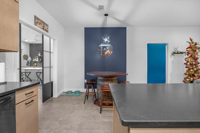 kitchen with dishwasher, light brown cabinetry, decorative light fixtures, and ceiling fan