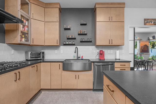 kitchen with dishwasher, light brown cabinetry, range hood, and sink