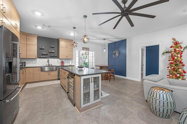 kitchen featuring stainless steel fridge, light brown cabinetry, ceiling fan, a center island, and hanging light fixtures