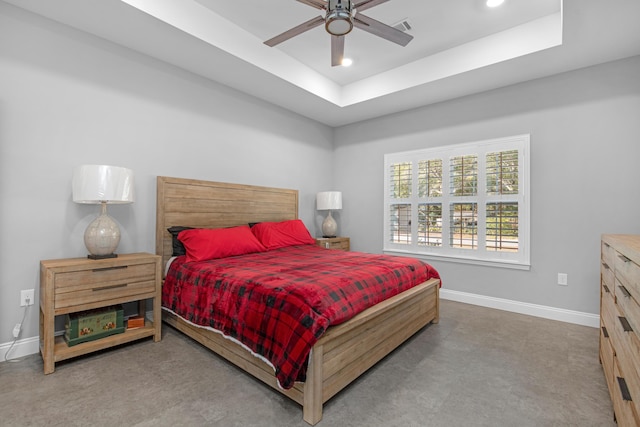 bedroom with a raised ceiling and ceiling fan