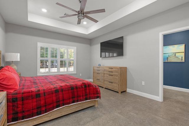 bedroom with a raised ceiling and ceiling fan