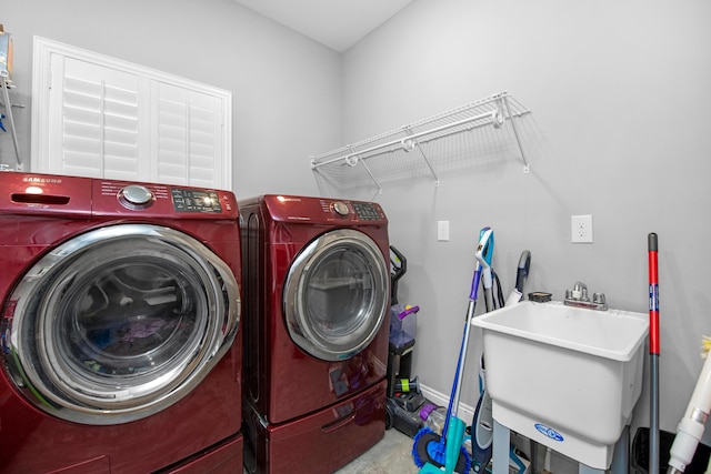 washroom with separate washer and dryer and sink