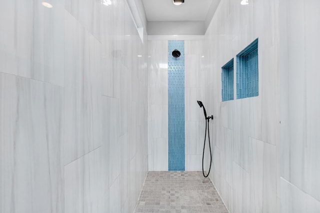 bathroom with tiled shower