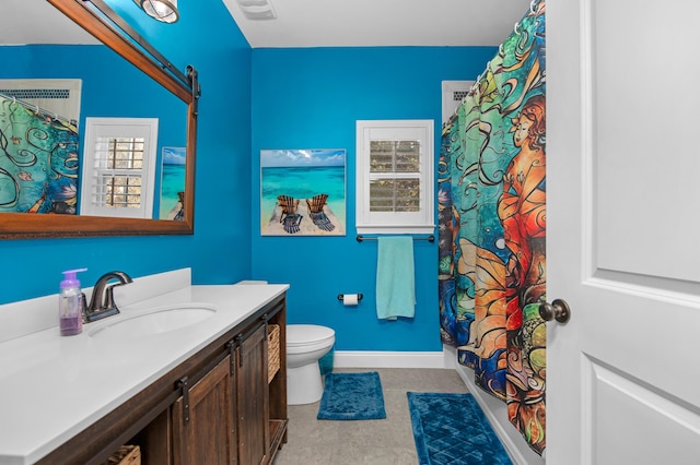 bathroom with vanity, curtained shower, and toilet