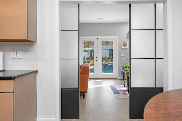 kitchen featuring french doors and backsplash