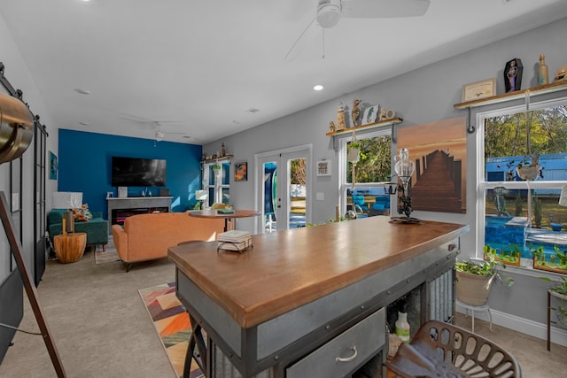 dining space featuring ceiling fan and french doors