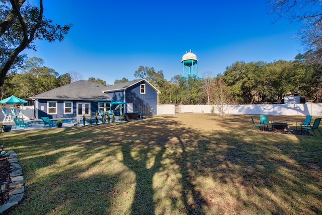 view of yard with an outdoor fire pit, an outdoor structure, and a swimming pool