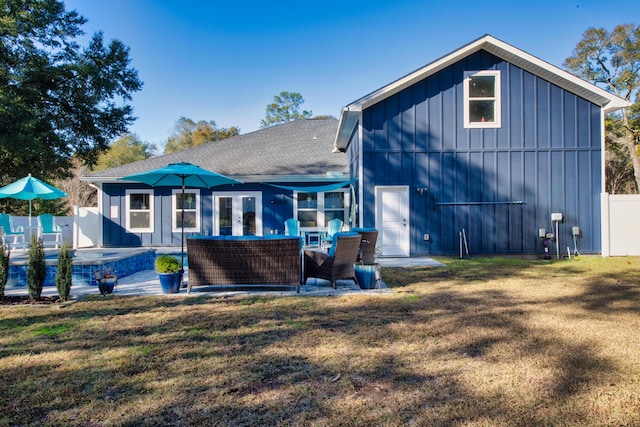 back of property with a lawn, an outdoor living space, and a patio