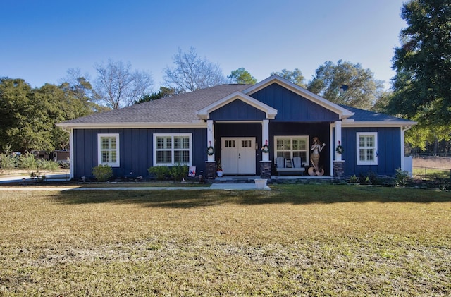 craftsman house with covered porch and a front lawn