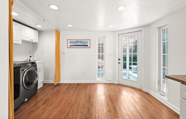 washroom with baseboards, light wood finished floors, recessed lighting, cabinet space, and a sink