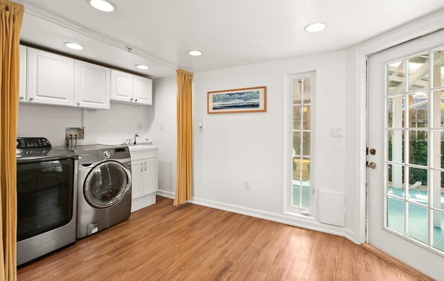 washroom with baseboards, washing machine and clothes dryer, light wood-style flooring, recessed lighting, and cabinet space