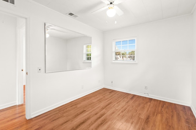 empty room featuring visible vents, ceiling fan, baseboards, and light wood-style floors