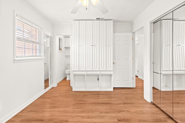 unfurnished bedroom with visible vents, a closet, light wood-style flooring, and crown molding