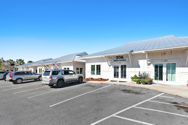 view of parking featuring french doors