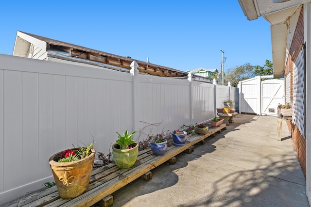 view of patio with a fenced backyard and a gate