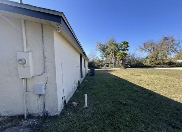 view of side of property with a yard