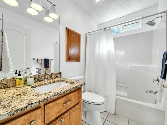 full bathroom with vanity, tile patterned floors, toilet, a textured ceiling, and shower / tub combo with curtain