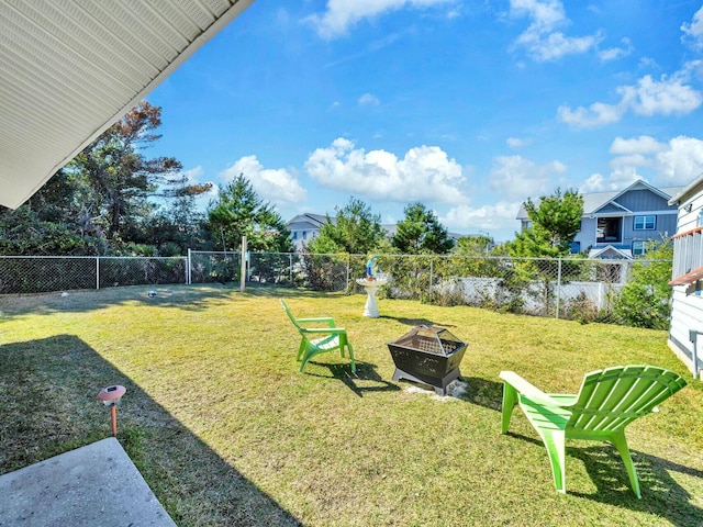 view of yard with a fire pit