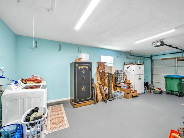 garage with a garage door opener and washing machine and clothes dryer