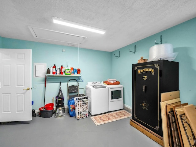 clothes washing area featuring a textured ceiling and washing machine and clothes dryer