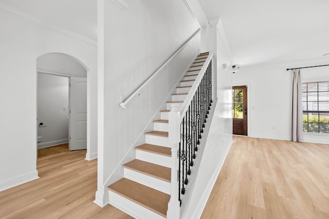 258 Tropical Breeze Dr, Santa Rosa Beach, FL 32459 - stairway with arched walkways, crown molding, and wood finished floors