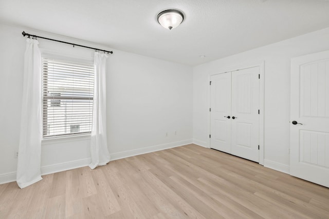 258 Tropical Breeze Dr, Santa Rosa Beach, FL 32459 - unfurnished bedroom with light wood-type flooring and a closet