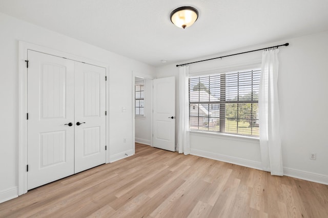258 Tropical Breeze Dr, Santa Rosa Beach, FL 32459 - unfurnished bedroom with light wood finished floors and a closet