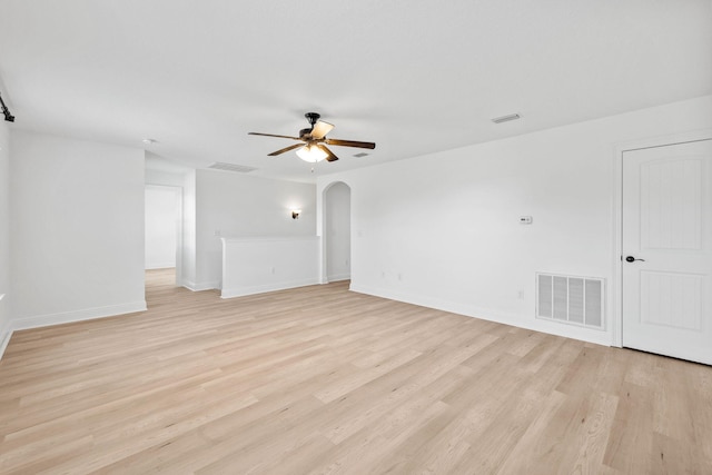 258 Tropical Breeze Dr, Santa Rosa Beach, FL 32459 - unfurnished living room with a ceiling fan, arched walkways, and light wood-style floors