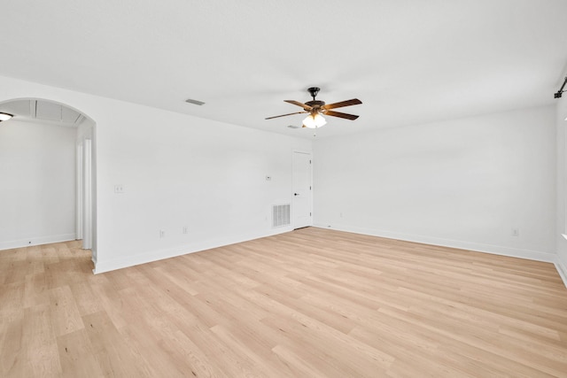 258 Tropical Breeze Dr, Santa Rosa Beach, FL 32459 - empty room featuring ceiling fan, arched walkways, and light wood-style floors