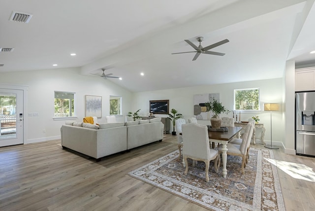 dining area with ceiling fan, lofted ceiling with beams, and light hardwood / wood-style floors