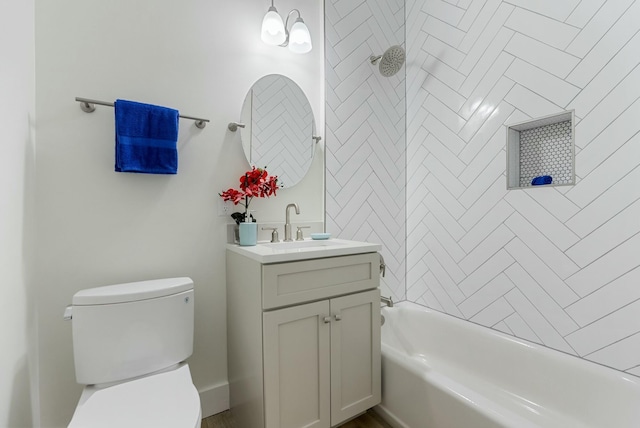 full bathroom with toilet, tiled shower / bath, and vanity