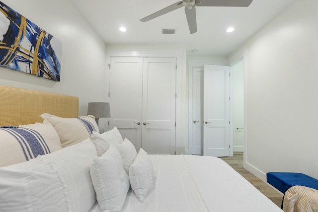 bedroom with ceiling fan, a closet, and wood-type flooring