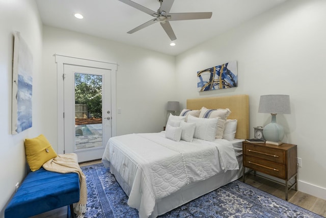 bedroom with dark hardwood / wood-style flooring, access to exterior, and ceiling fan