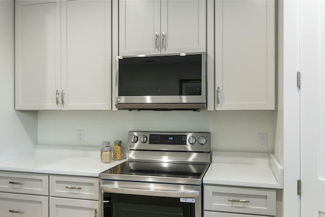 kitchen with white cabinetry and appliances with stainless steel finishes